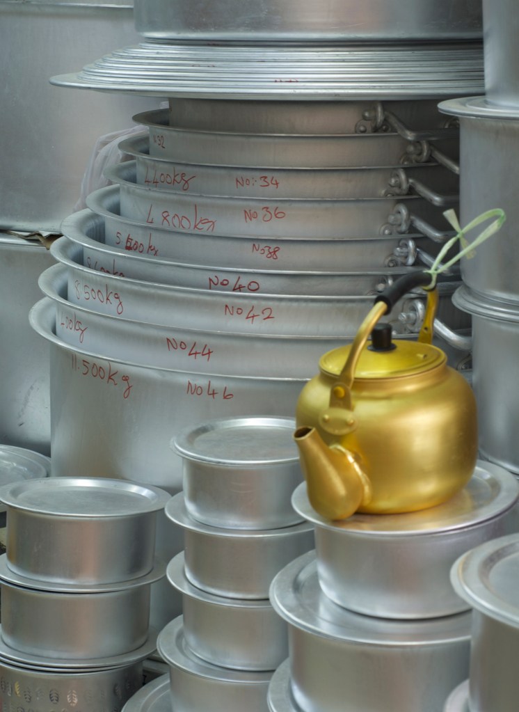 lots of different sized aluminum cooking pots - manama souk
